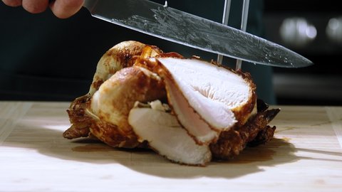 chef cuts the grilled chicken, cuts chiken close-up, Chopping grilled chicken slow motion, Cut Roasted Chicken 