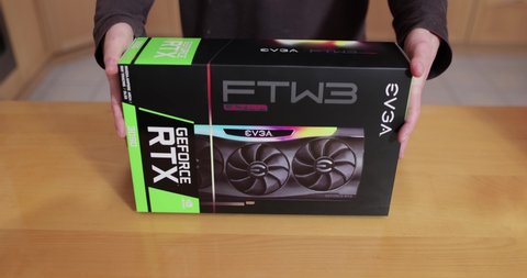 Budapest, Hungary - Circa 2021: Buying an Nvidia Geforce RTX 3090 Graphics Card made by EVGA in its box. High end GPU of the Nvidia RTX 30 series hard to get because of shortage lasting well into 2021