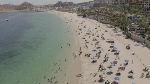 People enjoying Medano Beach shoreline, Cabo San Lucas, Los Cabos, México. Aerial establisher