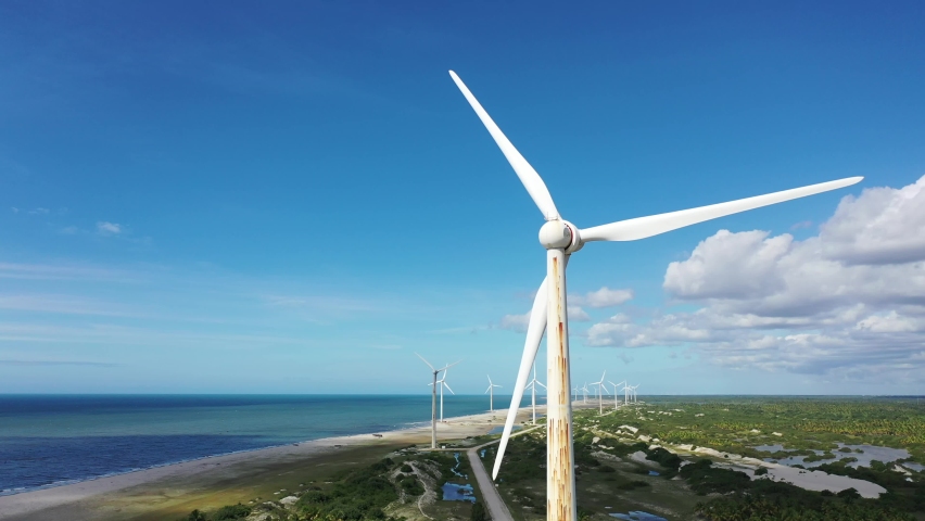 Aerial landscape of clean energy wind farm at near Jericoacoara, Ceara, Brazil. Aeolian turbine. Aeolian energy. Sustainable energy turbines. Clean energy to control climate change and save planet Royalty-Free Stock Footage #1072917788
