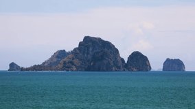 Timelapse of boats at Ao Nang, Krabi with Koh Poda in the background on a sunny day in Thailand