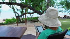 senior woman reading ebook from tablet during summer vacation - Powered by Shutterstock - Get 15% off with code: PIKWIZARD15