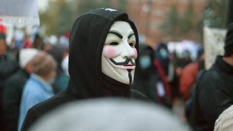 Russia, Khabarovsk, 24.10.2020: Anonymous masked protester. Peaceful people political demonstration, opposition guys rally. Striking protesting city riot. Guy Fawkes on city protest. Non violent march