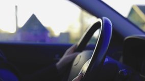 Video, woman hands drive a car, fingers lie on the steering wheel, beautiful fingers female hands