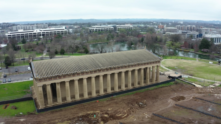 City skyline of Nashville and Pantheon in foreground in drone circle view