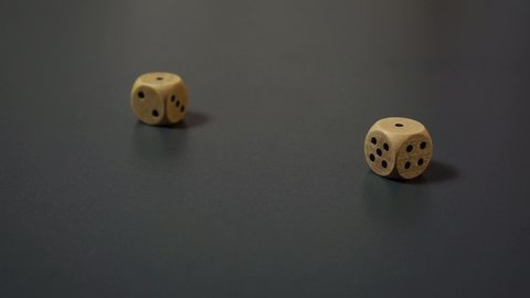 Dice Roll - Two Wooden Dice Rolling On Black Table Getting Double One. - close up