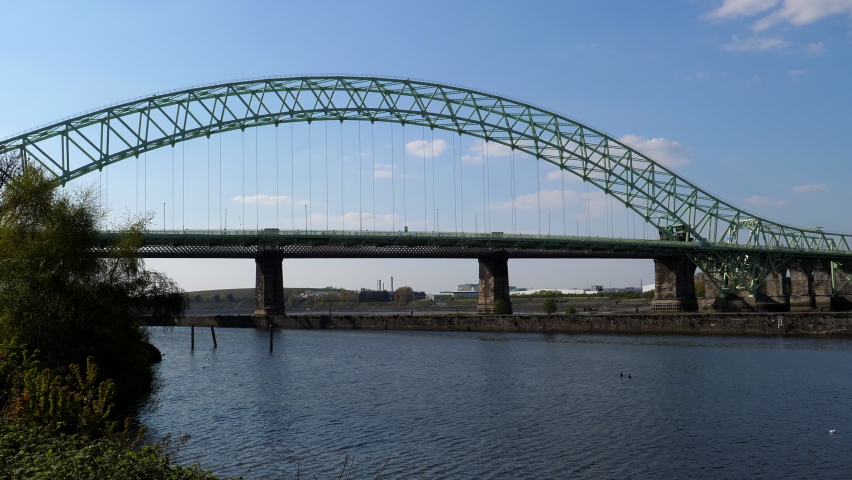 Silver Jubilee steel arch Bridge over River Mersey and Manchester Ship Canal, stationary shot from Runcorn side.