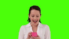 Brunette woman very happy to receive a gift against a green screen