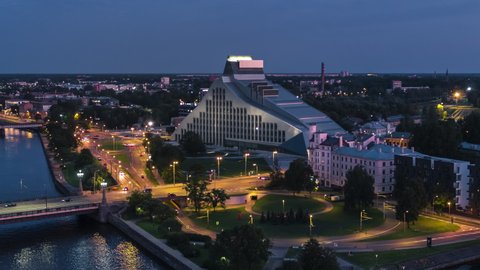 Riga, Latvia - circa 2020 - Establishing Aerial View Shot of Riga, Riga skyline, Latvia at night evening