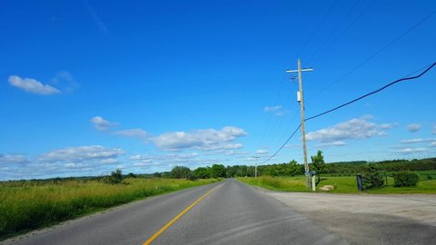 Driving Rural Farmland During Summer Day.  Driver Point of View POV Drive Scenic Farm Landscape.