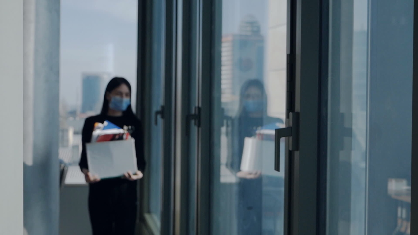 Young woman at the window in the office, loses her job, holding personal belongings in a box, quit her job, fired because of the crisis.Slow motion | Shutterstock HD Video #1072973999
