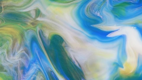 Abstract light pastel streams flow along the plane on a blue background. Marble texture. Fluid art. Liquid abstractions.