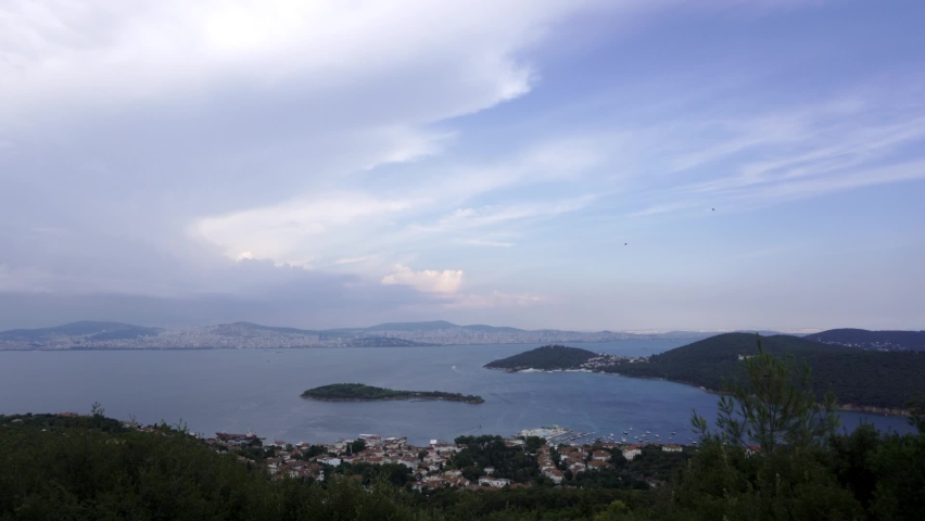 The view of the marmara sea and the islands, one of the historical and touristic islands of istanbul far from the city, in the summer, the cloudy blue sky, the skyline of the Istanbul city behind. Royalty-Free Stock Footage #1072977695