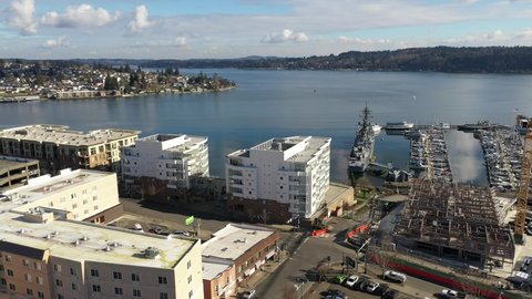 Cinematic aerial drone footage of Bremerton, Manette, Sinclair Inlet, Waterman, Puget Sound, the downtown marina, ferry terminal and shops in the background in Kitsap County, Washington State