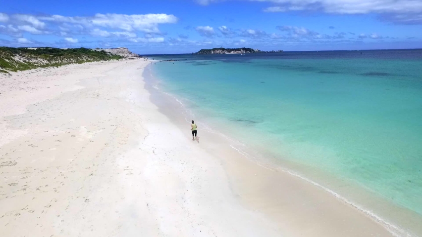 Women Running along Shore of Hamilton Beach in Queensland, Australia, Forward Aerial