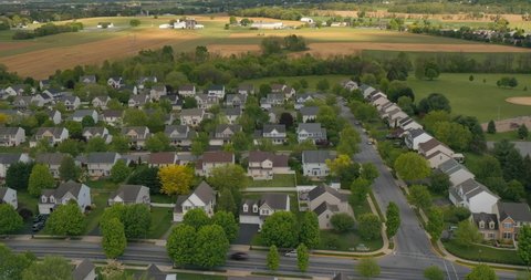 Aerial timelapse, hyperlapse of American residential home community. Clouds cast shadows between bright sun. Neighborhood and friendly neighbor concept. Suburb real estate growth. Property prices.