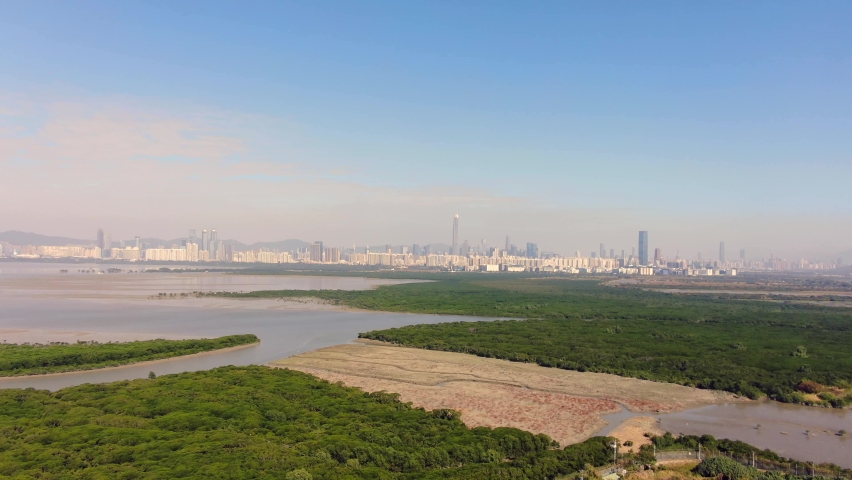 Hong Kong and Shenzhen border line over Hong Kong rural houses with Shenhzen skyline in the horizon, Aerial view.