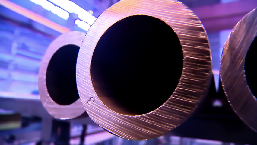 Holes of Copper Pipes in Factory of Non Ferrous Metal. Beautiful Panoramic Close Up to the Pipes in a Row. Industrial Line at Factory of Non-Ferrous Metal Production plant. Neon Purple Colors. Royalty-Free Stock Footage #1072993544