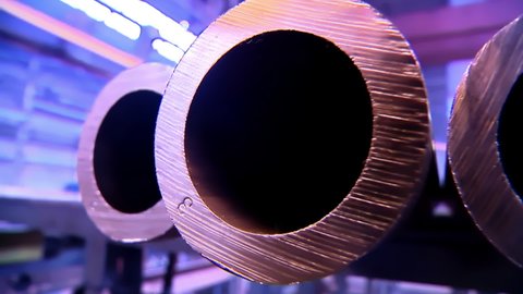 Holes of Copper Pipes in Factory of Non Ferrous Metal. Beautiful Panoramic Close Up to the Pipes in a Row. Industrial Line at Factory of Non-Ferrous Metal Production plant. Neon Purple Colors.