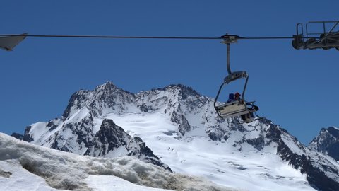 Long cable car line and ski lift working on top of the mountain. Concept of travel and tourism in mountain at summer.