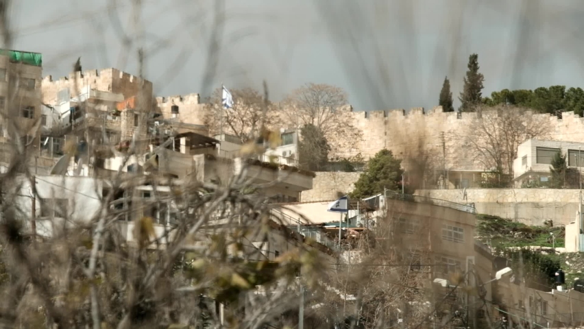Israeli flags are displayed above Jewish settlements amongst a (most predominantly) Palestinian neighborhood in East Jerusalem: Sheikh Jarrah. Jerusalem, Israel.