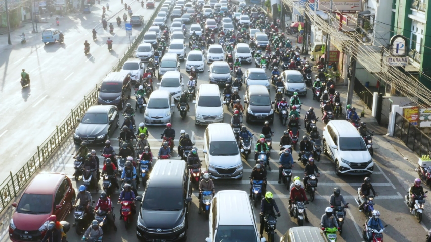 JAKARTA - Indonesia. May 18, 2021: Aerial view footage of hectic traffic with chaotic vehicles scramble on the road. Shot in 4k resolution