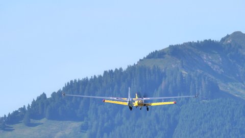 Zigermeet Airshow in Mollis Switzerland August 16th 2019. A small propeller plane tows a historic glider in flight. Let L-13 Blanik of the Red Bull Blanix Team