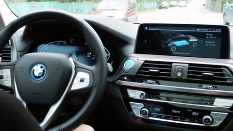 Tallinn, Estonia- May 20, 2021: Driving an electric car in a city. 
 Vehicle dashboard view during driving. Green energy zero-emission car interior view. Long-range electric vehicle. BMW iX3 dashboard