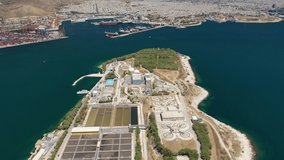 Aerial drone video of latest technology sewage and sludge processing plant in small island of Psitalia or Psyttaleia, Piraeus, Attica, Greece