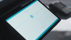 Close Up Footage of a Person Touching an Electronic Fingerprint Recognition Feature on a Digital Screen in Order to Make a Purchase in a Clothing Store. Customer Buying Items in Shop with Digital ID. - Powered by Shutterstock - Get 15% off with code: PIKWIZARD15