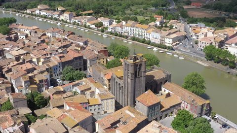 France, Agde, downtown with Saint-Etienne church, left to right drone aerial view