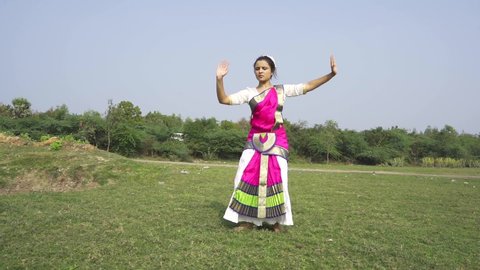 A bharatnatyam dancer displaying a classical bharatnatyam pose in the nature of Vadatalav lake, Pavagadh. Beautiful indian girl dancer in the posture of Indian classical dance bharatanatyam .