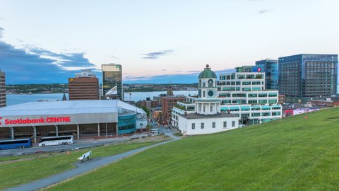 Halifax, NS, Canada - 2020-Jun-18: A evening time-lapse of the Town Clock at the back drop of Halifax downtown and scotia center on the left, Halifax, Nova Scotia