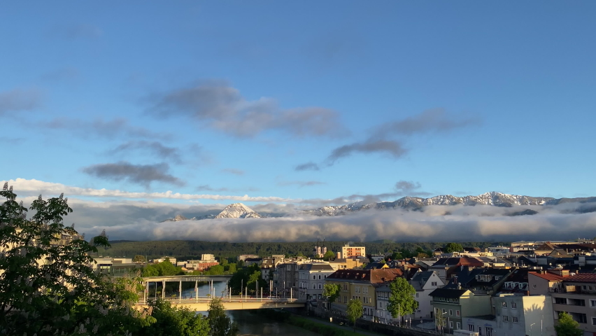 Evening panorama of the old Austrian city of Villach, in the federal state of Carinthia, overlooking the snowy Alps and the Drau River