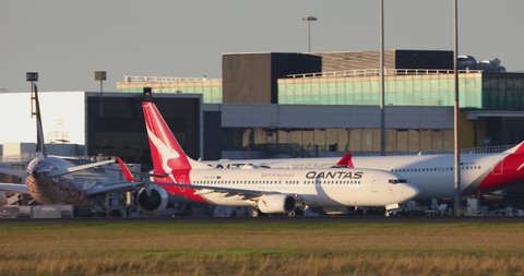 Melbourne, Australia - May 22, 2021: Qantas Boeing 737 airliner taxiing past the terminal buildings at Melbourne Airport in preparation for departure.