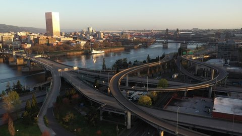 Cinematic dawn aerial drone video of Portland Pearl and Lloyd Districts, East Portland, Buckman Neighborhood, waterfront, Willamette River, Tom McCall Waterfront Park, and cityscape in Oregon
