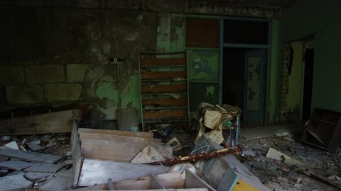Destroyed furniture and bookshelves in abandoned commercial building, Pripyat