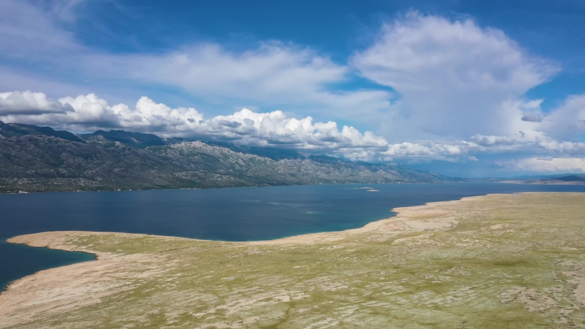Panorama Of Croatian Island Under White Clouds Across Adriatic Sea From Pag Bridge In Croatia. - aerial