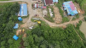 The video showing an aerial view of traditional small industrial facility in the tropical forest of Borneo, Southeast Asia.