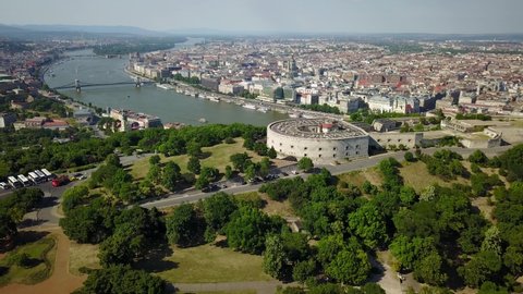 Cinematic aerial trucking drone footage of Castle Hill, Buda Castle, Margaret Island viewed from Gellért Hill and the Citadella fortress with the Danube river, bridges and Pest in Budapest, Hungary