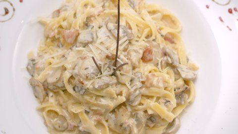 Spaghetti in mushroom sauce with grated cheese, close-up, Mediterranean
