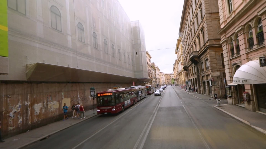 Streets of Rome view from the window of a car. People walk the streets in Rome. Old streets of Rome. A trip by car through the streets of Rome