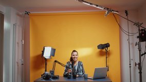 Professional studio set of video blogger recording new episode about camera lens. Content creator new media star influencer on social media talking video photo equipment for online internet web show
