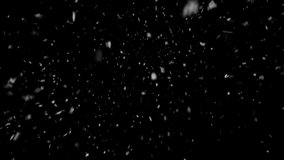 White glowing snowflakes falling on cool black background