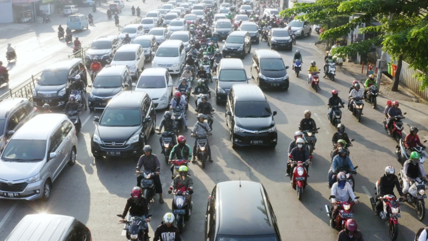 JAKARTA - Indonesia. May 18, 2021: Drone view of hectic traffic with chaotic vehicles scramble on the road. Shot in 4k resolution