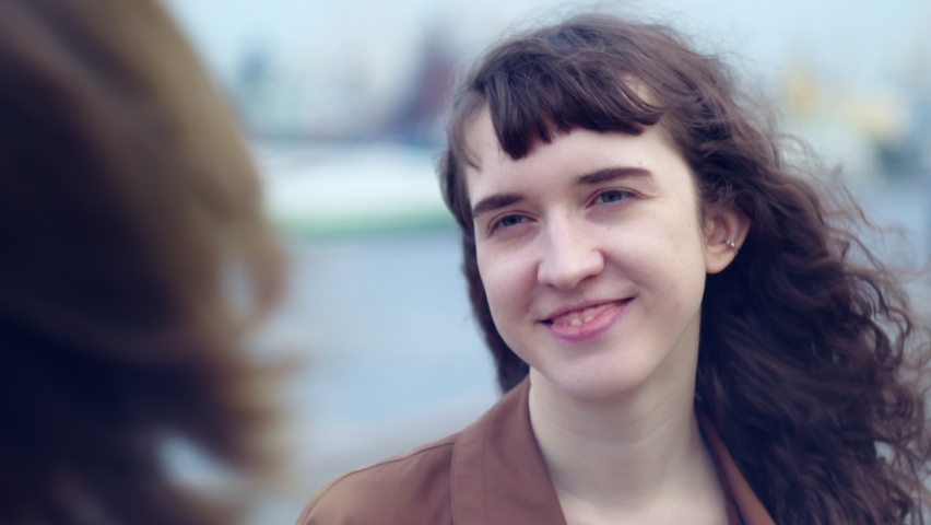 a woman gives another woman flowers, a portrait of a joyful birthday girl. lgbt relationships and unconventional marriage, happiness. 