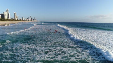 Aerial view of a group of Nippers paddling out on boards during a morning training session at Mermaid Beach Gold Coast Australia