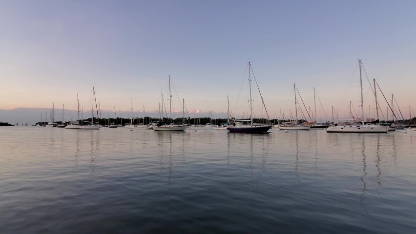 Sailboats at anchor off Dinner Key Marina in Coconut Grove, Florida in early morning light 4K.