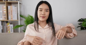 Front view of Smiling young asian woman blogger vlogger influencer working at home. Girl speaking looking at camera talking making videochat or conference call. Happy female young 20s woman.