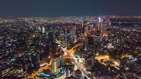 Beautiful Aerial Drone Hyperlapse view of urban modern Mexico City center with tall skyscrapers and flashing City lights at night, Hyper Lapse of City movement
